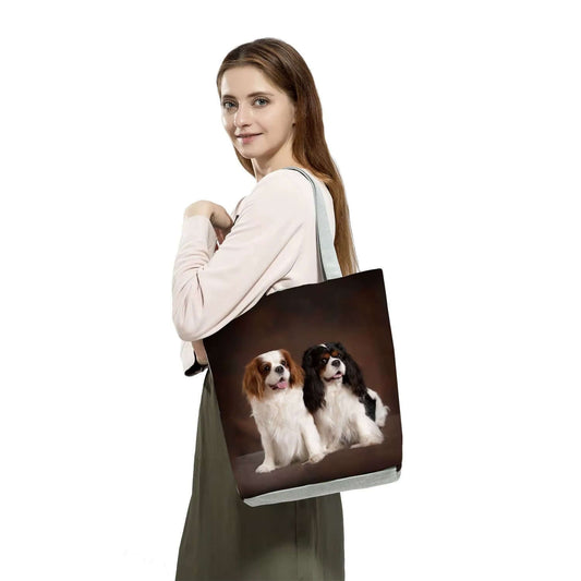 Woman carrying a dog print tote bag for women featuring two adorable dogs on the front.
