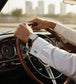 luxury tuxedo shirt studs showcased on a gentleman's cuff while driving a classic car